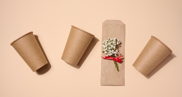 Empty brown paper disposable cups on a beige background concept ecofriendly zero waste