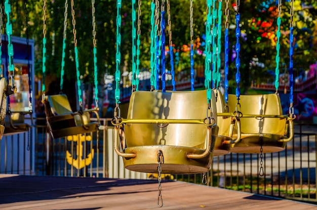 Empty carousel chairs in an amusement park.
