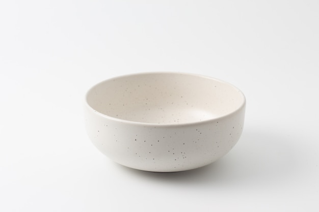 Empty ceramic bowl over white background