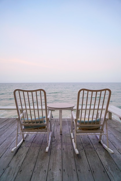 Empty chair on balcony with sea background