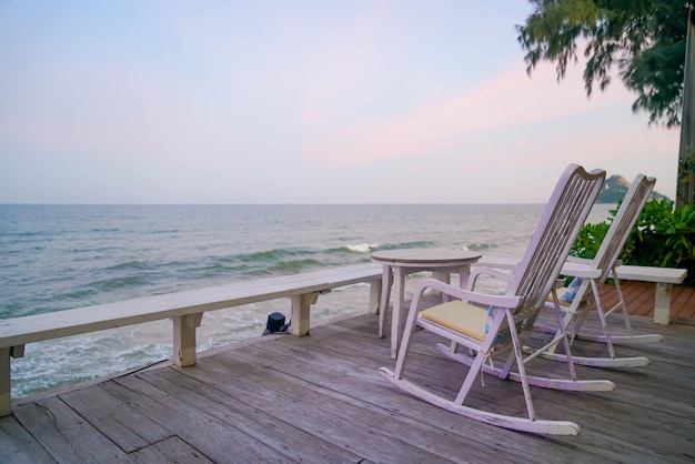 Empty chair on balcony with sea background