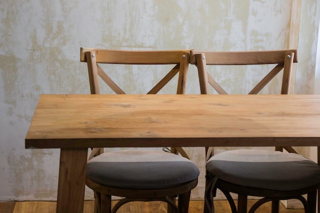 Empty chairs and table against wall at home