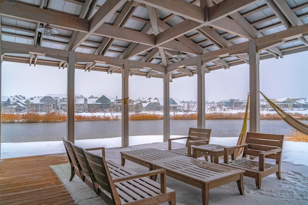 Empty chairs and tables in restaurant by sea against sky