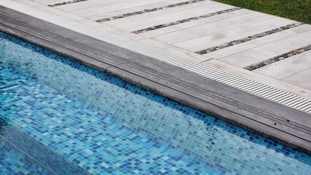 Empty chaise longue and swimming pool