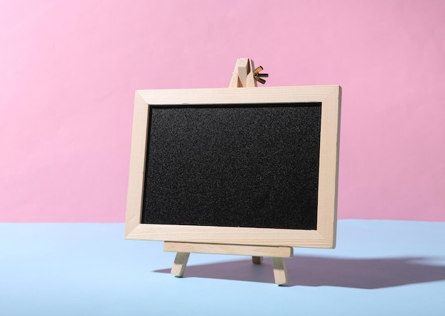 Empty chalk board on blue pink pastel background