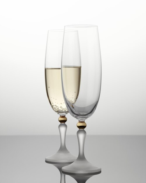 Empty champagne glass on gray background There is a glass of champagne behind an empty glass Selec