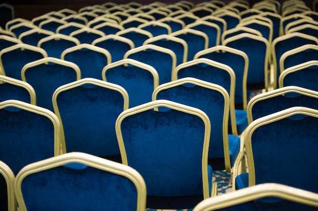 Empty cinema auditorium. a large number of blue velvet chairs in a row.