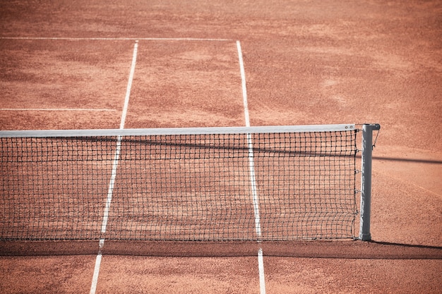 Empty Clay Tennis Court and Net. Horizontal shot