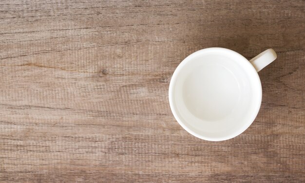 Empty clean cup on wood table.