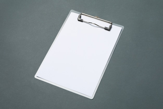 Empty clipboard on light black background, space for text