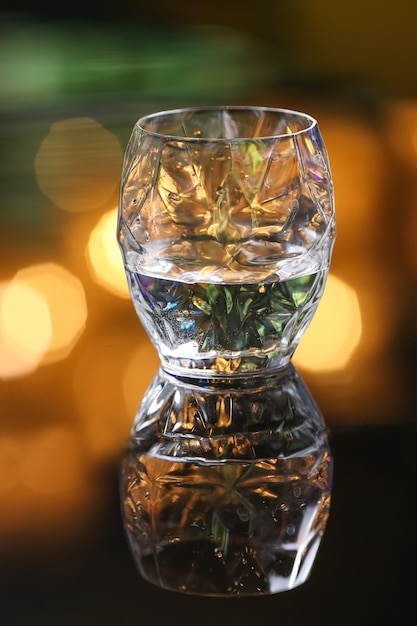 Empty cocktail drink glass on blur green background