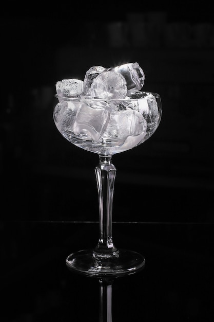 Empty cocktail glass with ice cubes