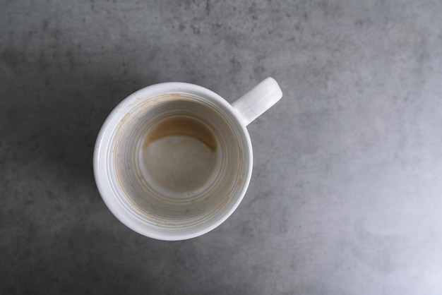 Empty coffee cup after drink on gray table