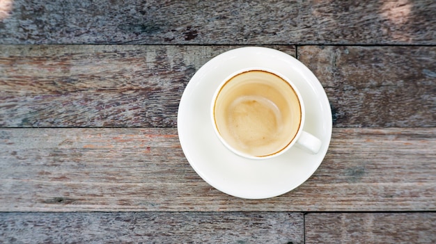 Empty coffee cup after drink on a wooden table.