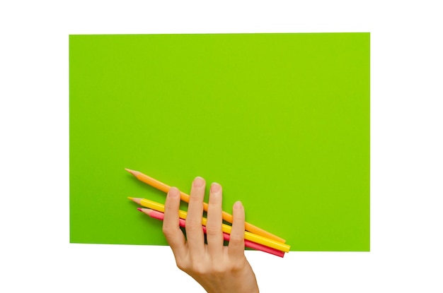 An empty colored poster in his hand and pencils Isolated on a white background Copy space