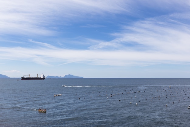 Empty container cargo ship in the blue sea. Aerial view