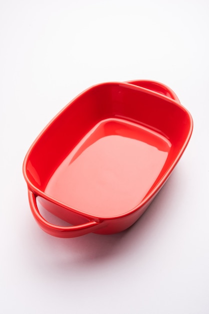 Empty Crockery - red ceramic bowl or bakeware without food on white background