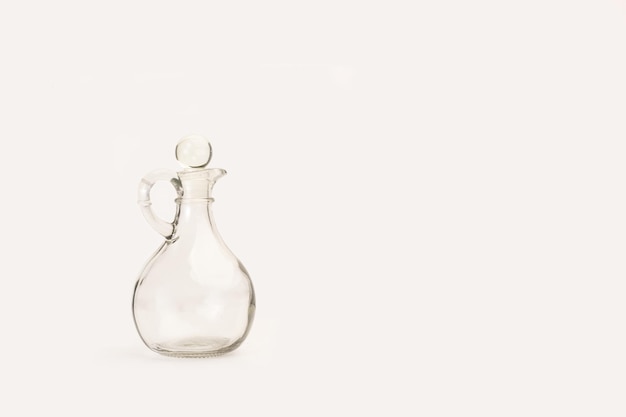 A empty crystal oil can on a white background with copy space