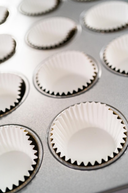 Empty cupcake liners in cupcake pan ready for baking.