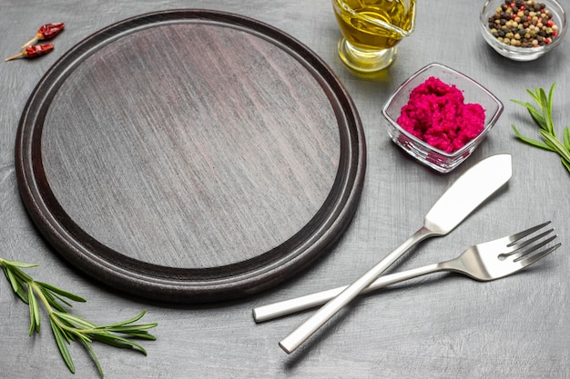 Empty cutting board knife and fork on table