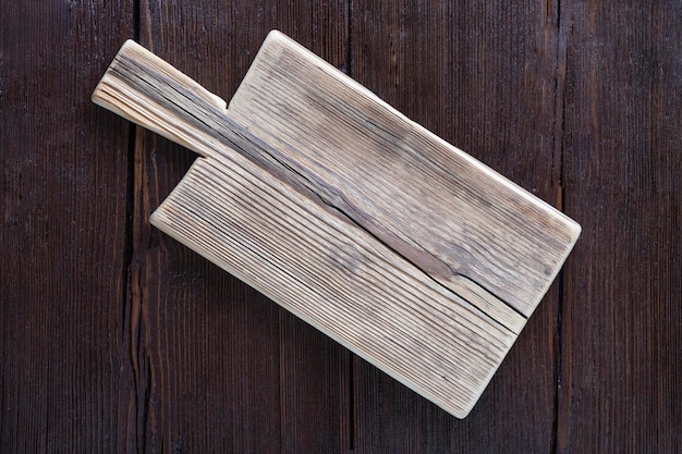 Empty cutting board on wooden brown background