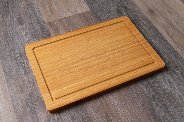 Empty cutting board on a wooden table