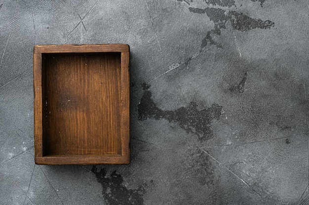 Empty dark wooden box with copy space for text or food top view flat lay on gray stone table background