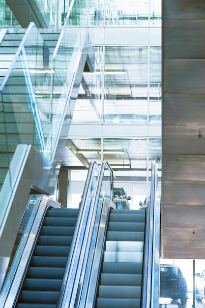 Empty escalator inside a glass building