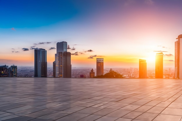 Empty floor and modern city skyline with building at sunset