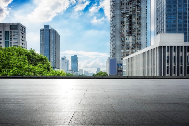 Empty foreground square and city buildings background