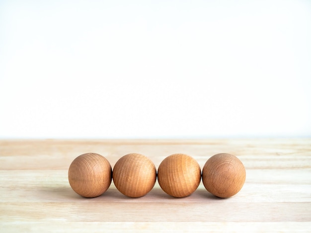 Empty four blank wooden spheres for your text or icon design isolated on white background with copy space Blank template 4 wood ball front view for business banner concept