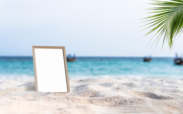 Empty frame board mock up on sand beach and blue sea background for text or design displays