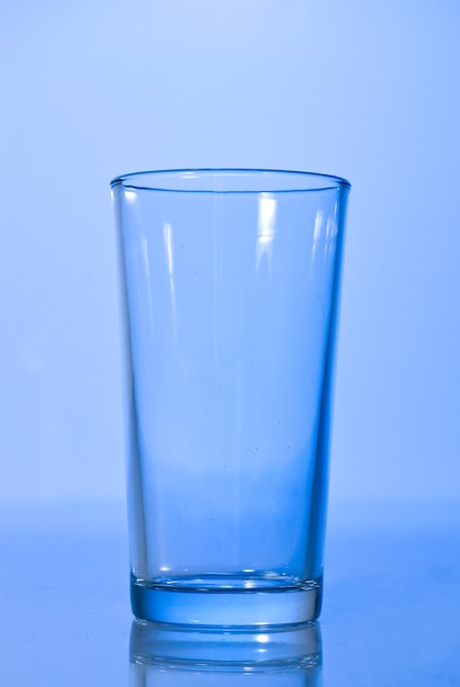 Empty glass on blue