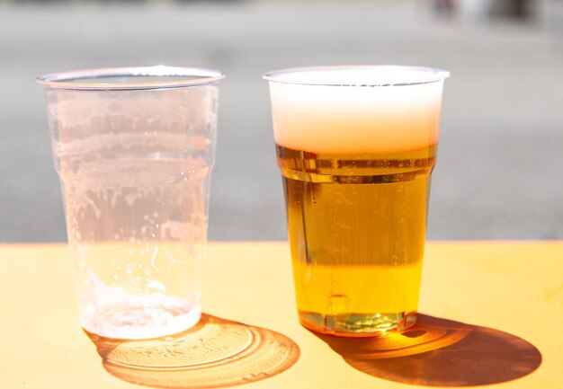 Empty glass and full glass of beer conceptual image of optimism and pessimism