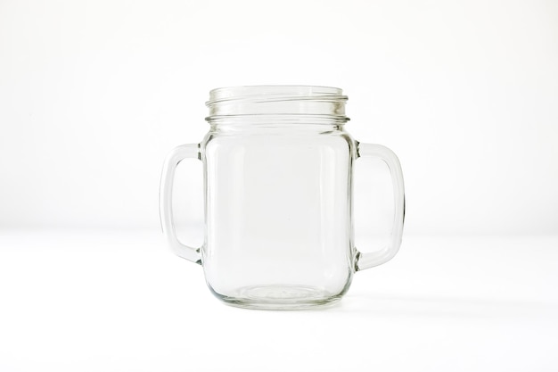 Photo empty glass mason jar with handles