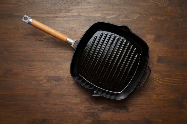 Empty grill pan for frying bbq on wooden table