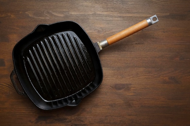 Empty grill pan for frying bbq on wooden table