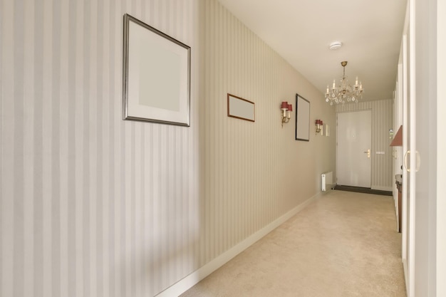 an empty hallway in a new house with striped wallpapers on the walls and white trim around the door