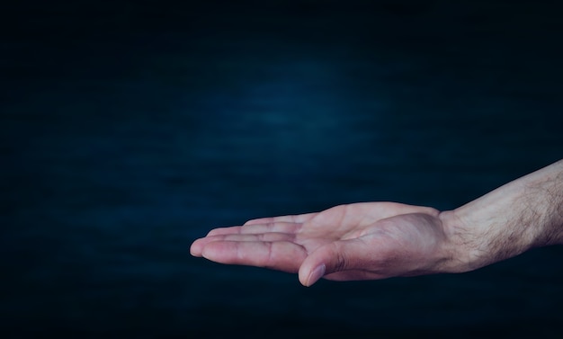 Empty hand on dark blue background