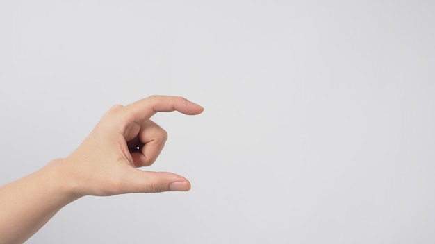 Empty hand doing pick or hold gesture on white background.