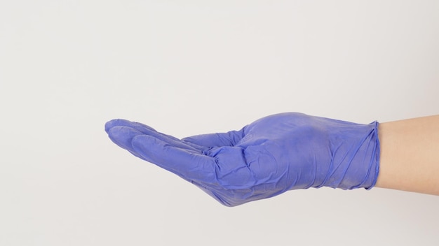 Empty hand wear violet latex glove doing sign for help on white background side view