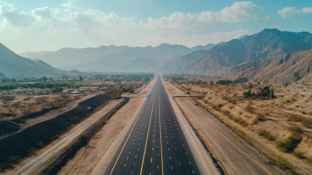 Empty highway leading into the mountains aerial perspective with copy space for text or design