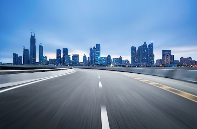 Empty highway with cityscape and skyline of qingdao, China.