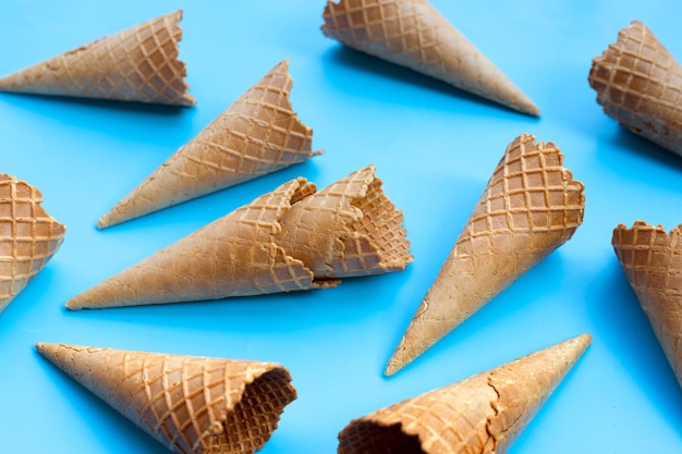 Empty ice cream cone on blue background