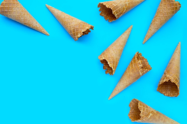 Empty ice cream cone on blue background