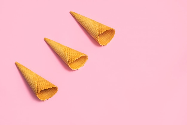 Empty ice cream cones on soft pink table