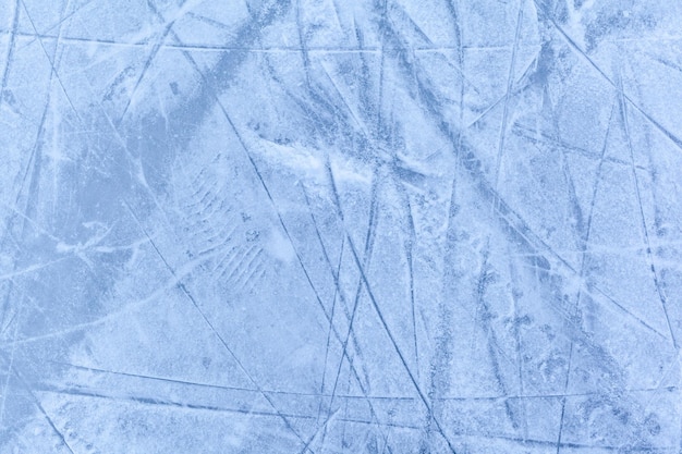 Empty ice rink with skate marks after the session outdoor.skating ice rink texture covered with snow