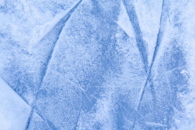 Empty ice rink with skate marks after the session outdoor. skating ice rink texture covered