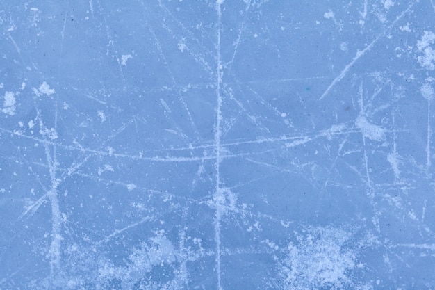 Empty ice rink with skate marks after the session outdoor. skating ice rink texture covered