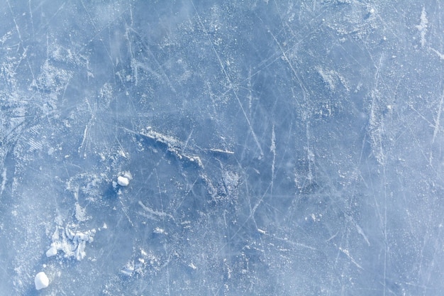 Empty ice rink with skate marks after the session skating ice rink texture covered with snow